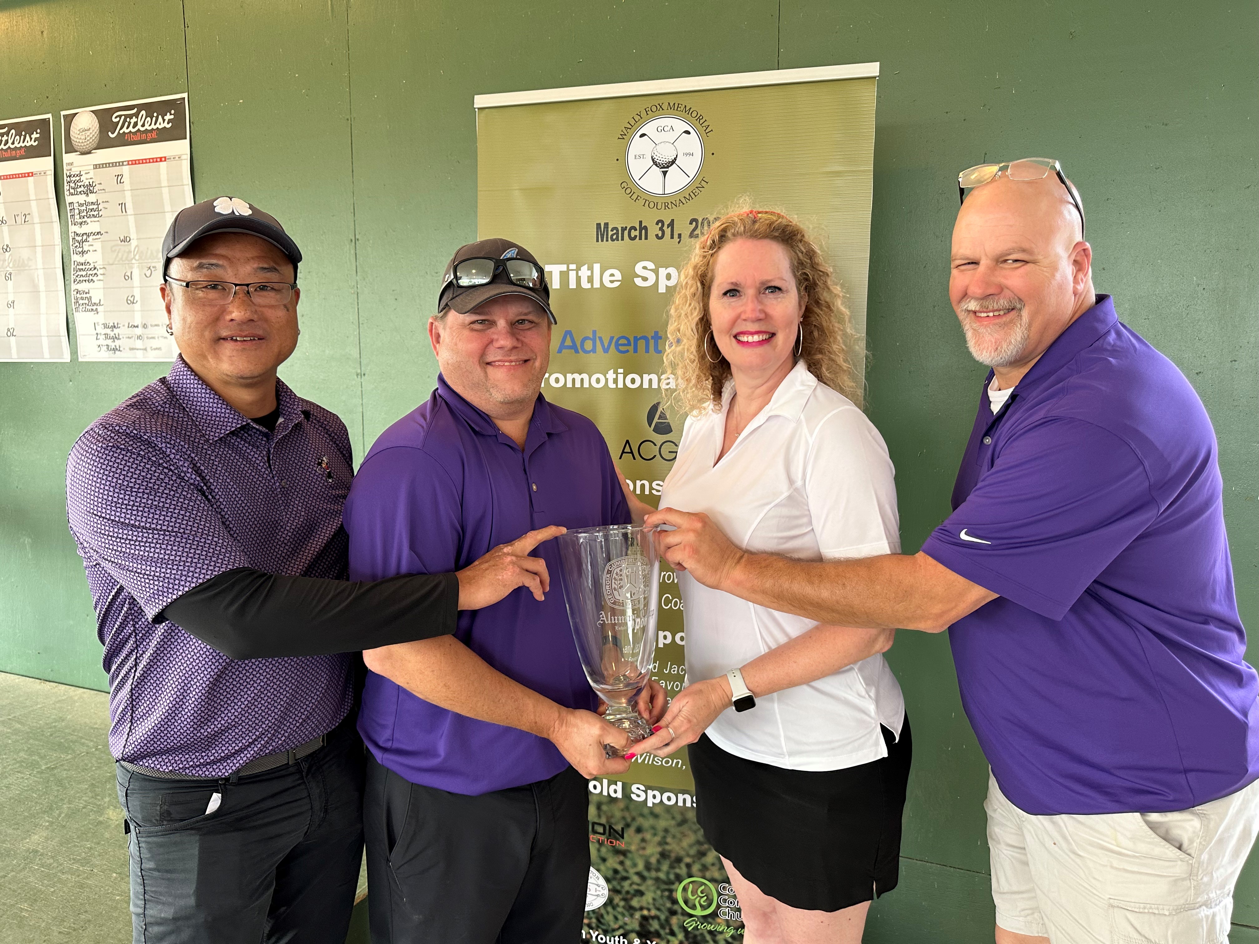 Golf Tournament Winners holding Trophy
